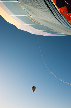 Aerial view of A hot-air balloon seen from the basket of a second balloon. Namib Desert, NamibRand Nature Reserve, Namibia.