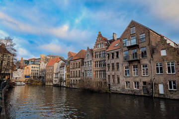 Historic buildings along the waterway in Ghent, Belgium, under a beautiful sky during the late afternoon