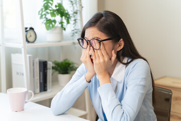 woman taking off glasses tired of computer work suffering from eye strain tension