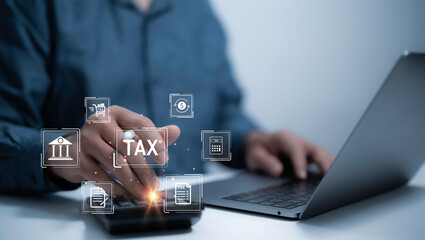 Businessman use laptop to complete Individual income tax return form online for tax payment. Financial research,government taxes and calculation tax return concept. Tax and Vat concept