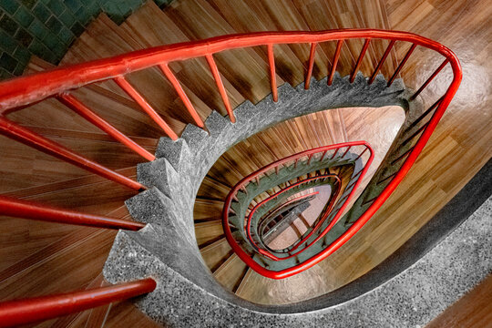 View of spiral staircase with seashell-like design and elegant red railing, Ginza, Tokyo Metropolitan City, Japan.