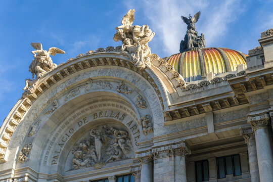 View of the majestic bellas artes palace with ornate facade and grand dome under a blue sky, Cuauhtemoc, Mexico.