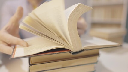 book close-up flipping pages. man reading a book in the library close-up. education bookstore concept. university book turn pages slow motion video. bookstore hands men reading a lifestyle book