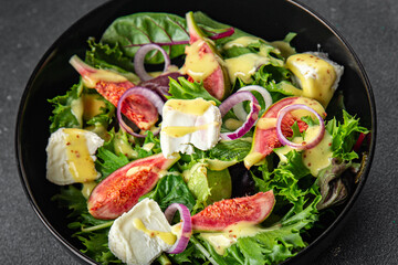 fig salad green lettuce, figs, soft cheese fresh meal food snack on the table copy space food background rustic top view keto or paleo diet vegetarian vegan food