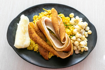 Delicious dish of chanfaina with pork skin with yucca and corn