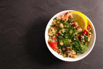 Top View of Tabbouleh Bowl with Fresh Parsley and lemon – Healthy Mediterranean Dish