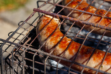 Sausages are fried on the grill