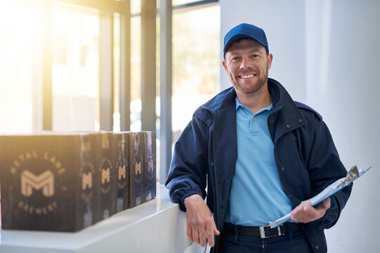 Delivery man, portrait and smile with clipboard for beer stock and brewery supplier inventory with service. Courier, parcel and happy with confidence, boxed and worker with order paperwork at job - Powered by Adobe