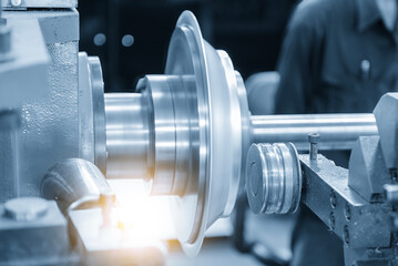 The metal spinning machine operation in the light blue scene with lighting effect.