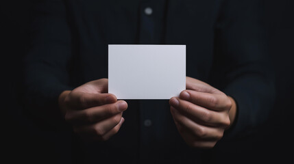 Businessman holding a blank business card