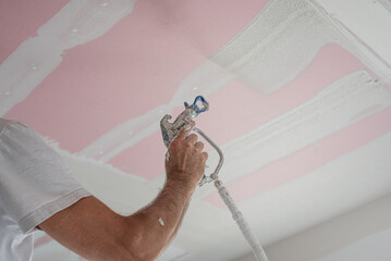 Make a plasterboard ceiling. Spraying gypsum putty to the plasterboard ceiling. It is using special...