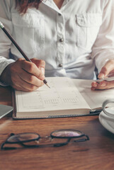 Male hand planner writing daily appointment On Calendar book, working space at home. Man plan and...