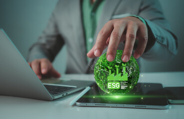 Businessman showing ESG and globe to represent analyze sustainable investment concept, Environment social governance investment business concept, Social business strategy, Environment, Sustainability.