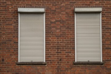 Fototapeta premium brick wall with old windows and shutters