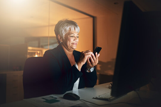 Office, phone and mature business woman on overtime, reading email and check schedule at night. Mobile, scroll and happy sales manager online with feedback for profit update, revenue growth and news