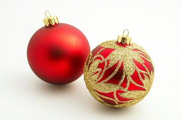 Red and gold holiday ornaments for Christmas, isolated on white background.
