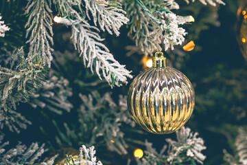 Gold Christmas decorations on the Christmas tree close-up.