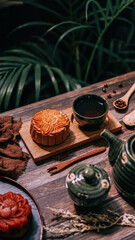 Chinese traditional festival mid-autumn baked mooncake and teacup on a wooden plate for menu restaurant in rustic cinematic dark tone horizontal no people