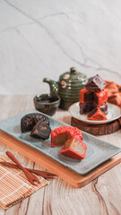 Chinese traditional festival mid-autumn delicacy assorted mooncake and tea on a plate for menu restaurant in bright airy tone vertical high angle view vertical