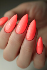 hand with coral orange polish manicure, long nails