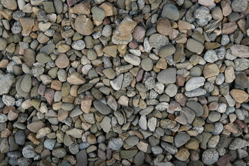 Processed collage of sea shore pebbles texture. Background for banner, backdrop or texture for 3D mapping