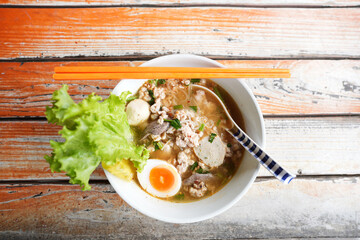 Stewed pork Noodles with egg on grunge wooden table