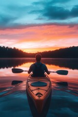 A man kayaking in water at sunset