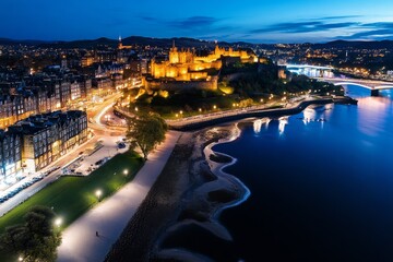 Fototapeta premium Aerial timelapse of Edinburgh at night, highlighting the illuminated Edinburgh Castle and historic Old Town