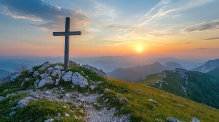 A cross on a hilltop with sunrise in the background.
