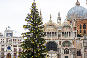 San Marco square in Venice, Italy with festive holiday season decorated illuminated Christmas tree,...