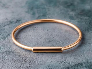 Thin wire bracelet with small bar accent, lying on concrete texture, modern urban jewelry concept