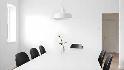 A clean, minimalist dining area with a white dining table, black dining chairs. 