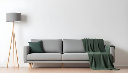Modern interior with a gray sofa and wooden floor lamp on a white background, mockup template for product presentation. White wall background with a grey fabric couch and a green blanket.