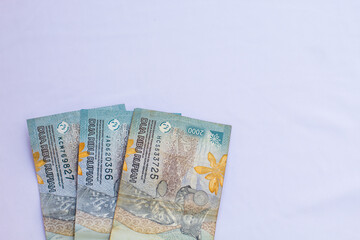 Indonesia October 13, 2024 6000 rupiah note in close up photo from top corner