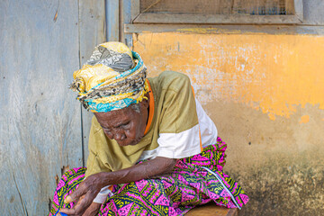 An aged woman sitting down