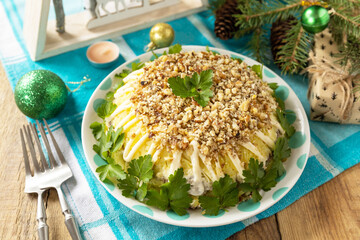 Christmas appetizer New year meal idea. Christmas New Year salad with potatoes, liver and nuts on...