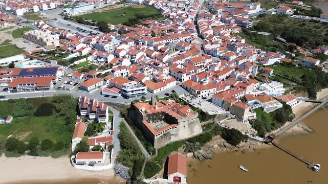 4k Drone footage capturing S&atilde;o Clemente Fort as it transitions from the Mira river to the picturesque white town of Vila Nova de Milfontes on the stunning Vicentine Coast, Beja, Portugal