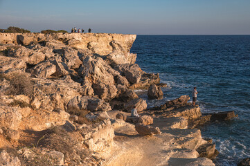 Tourists admiring Mediterranean sea from cliff near Cyclops Cave in Protaras, Cyprus