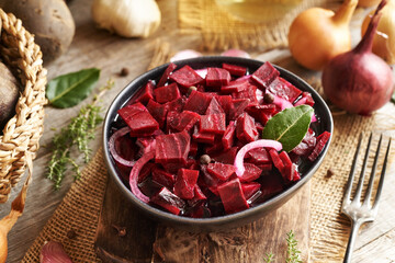 Fermented red beet kvass in a bowl with onions, garlic and spices