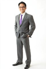 A confident man in tailored gray suit stands with smile, exuding professionalism and...