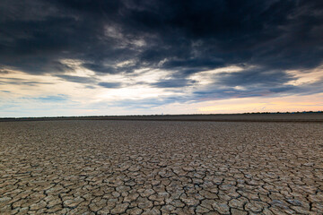 Arid landscape,Dry barren land with cloudy polluted sky, climate change and desertification concept