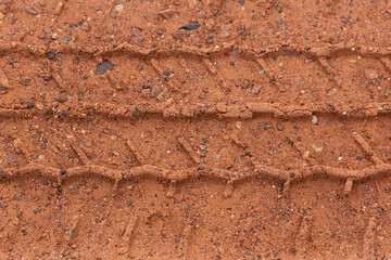 Close-up of car tire pattern on the ground,Close up of tire track or tire tread left behind in the mud or dirt