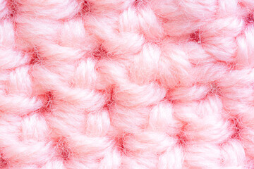 Close-up of pink knitted sweater,The reverse side of the cranberry-pink knitted fabric close-up as a background.