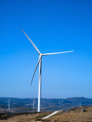 Wind turbine on the mountain, sunny blue skies