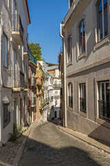 Steep narrow cobblestoned street Calcada Salvador Correia de Sa in the district of Misericórdia, Lisbon, Portugal.