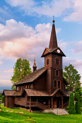 The beautiful wooden church of St. Anna is located on the outskirts of the village Tatranska Javorina (High Tatras, Slovakia) captured during the summer sunset