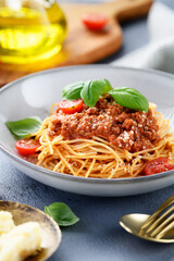 Traditional italian food - spaghetti bolognese with fresh basil leaves and parmesan cheese