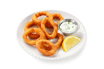 Delicious crispy fried calamari rings with white sauce and lemon slice. isolated on white background