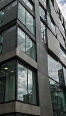 Modern office building with glass and gray panels.