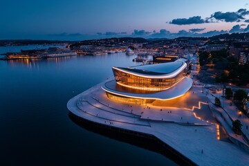 Fototapeta premium Aerial timelapse of Oslo at night, showcasing the waterfront and the glowing Oslo Opera House